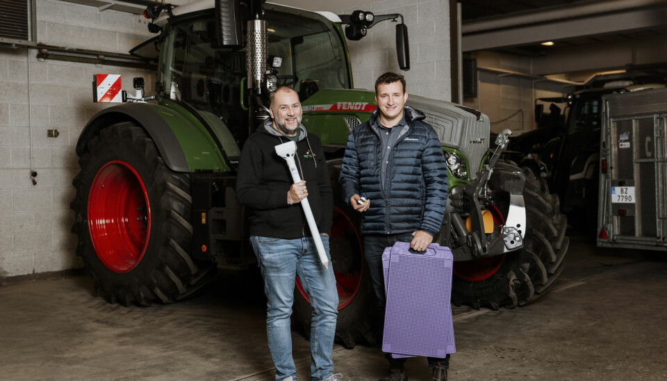 Jomar Ertsgaard og Truls Olve Hansen fotografert foran en Fendt mens de holder diverse småting i hendene forbundet med smartere landbruk.